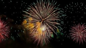 yellow and pink fireworks display in sky