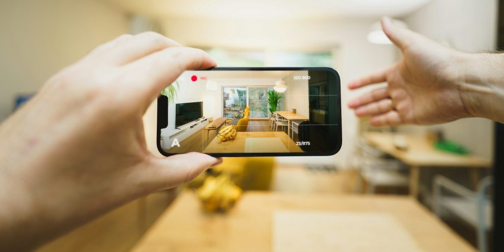 A person taking a picture of a kitchen